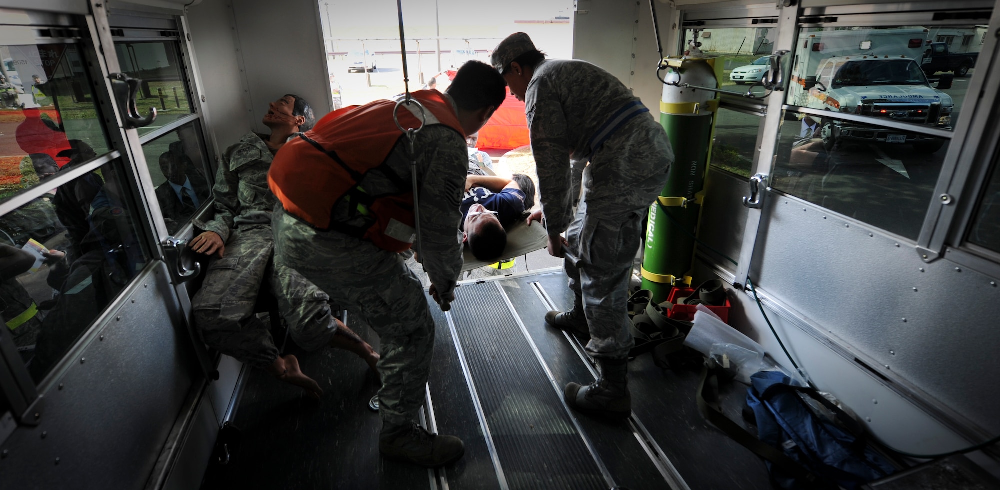 YOKOTA AIR BASE, Japan -- Airmen from the 374th Medical Operations Squadron load a wounded victim on a bus to transport to the hospital during an operational readiness exercise at Yokota Air Base, Japan, Nov. 7, 2011. The ORE tests Airmen's knowledge and ability in a variety of areas in both the peacetime and wartime mission. (U.S. Air Force photo/Staff Sgt. Stacy Moless)