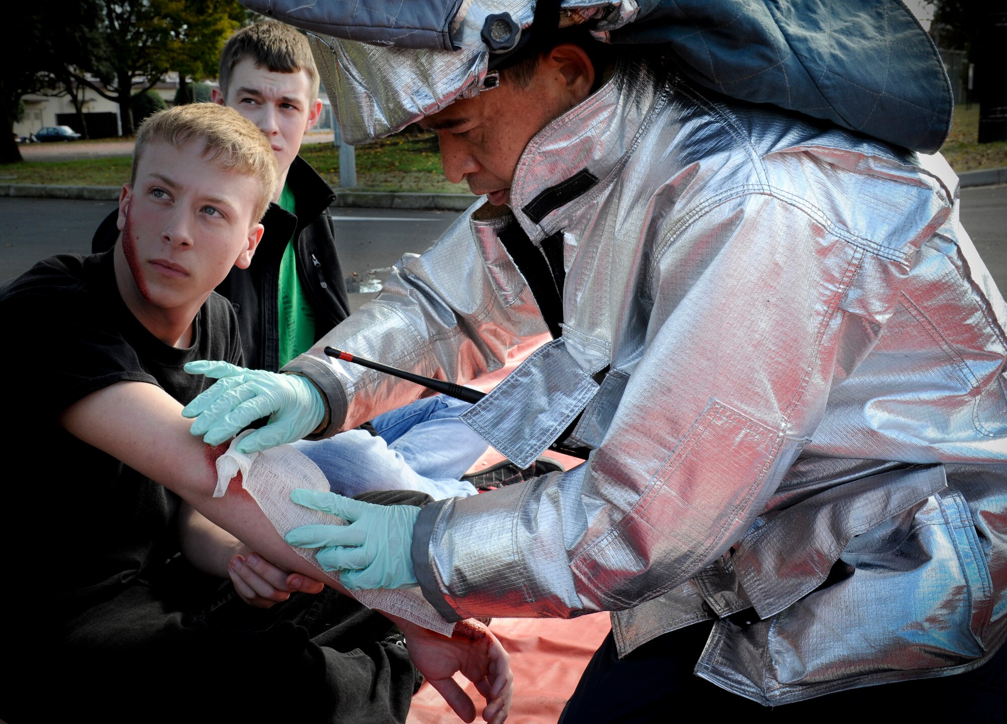 YOKOTA AIR BASE, Japan -- A firefighter from the 374th Civil Engineer Squadron treats a simulated wounded victim during an operational readiness exercise at Yokota Air Base, Japan, Nov. 7, 2011. The ORE tests Airmen's knowledge and ability in a variety of areas in both the peacetime and wartime mission. (U.S. Air Force photo/Staff Sgt. Stacy Moless)