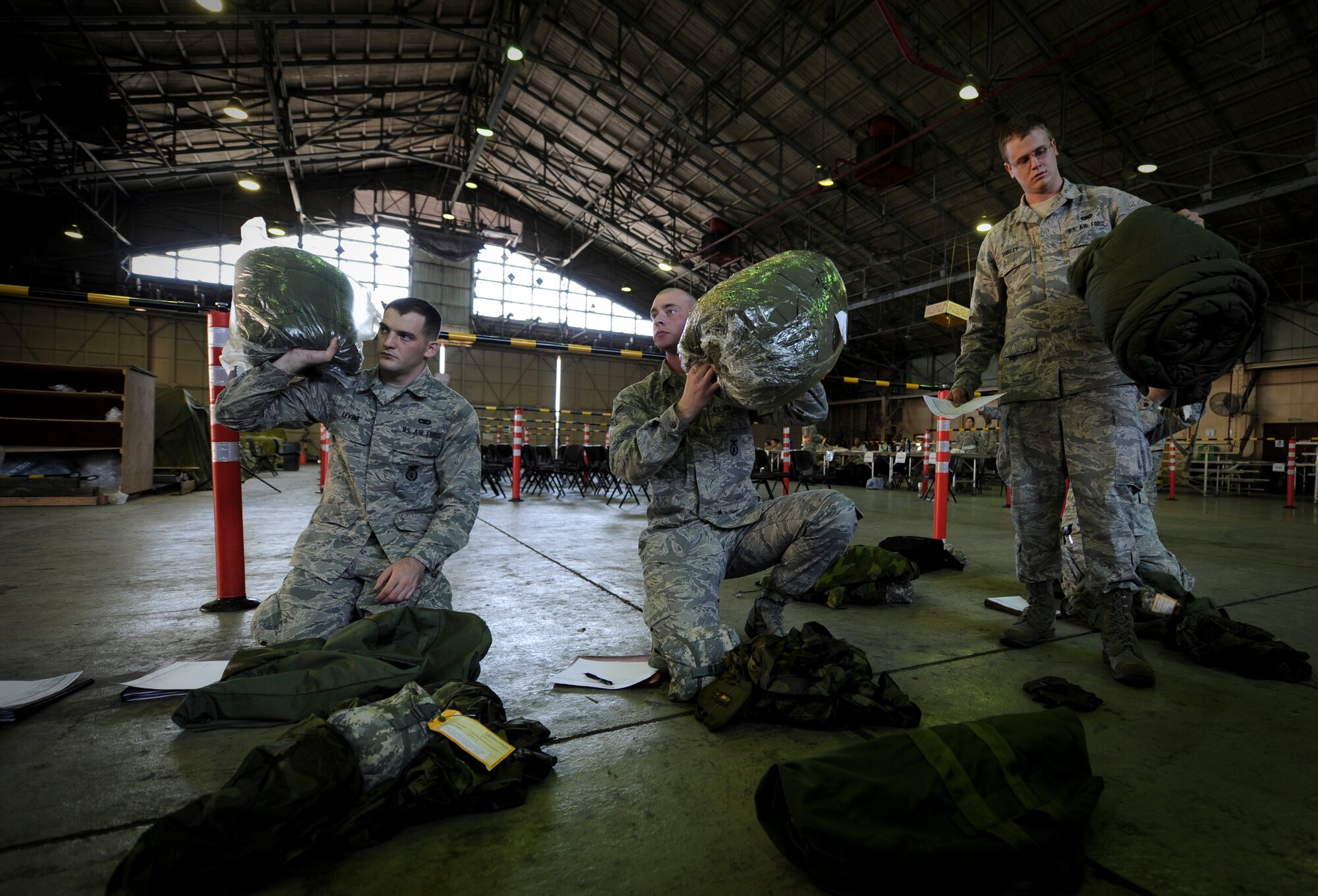 YOKOTA AIR BASE, Japan -- Members from the 374th Security Forces Squadron process through a deployment line during an operational readiness exercise at Yokota Air Base, Japan, Nov. 7, 2011. The ORE tests Airmen's knowledge and ability in a variety of areas in both the peacetime and wartime mission. (U.S. Air Force photo/Staff Sgt. Stacy Moless)
