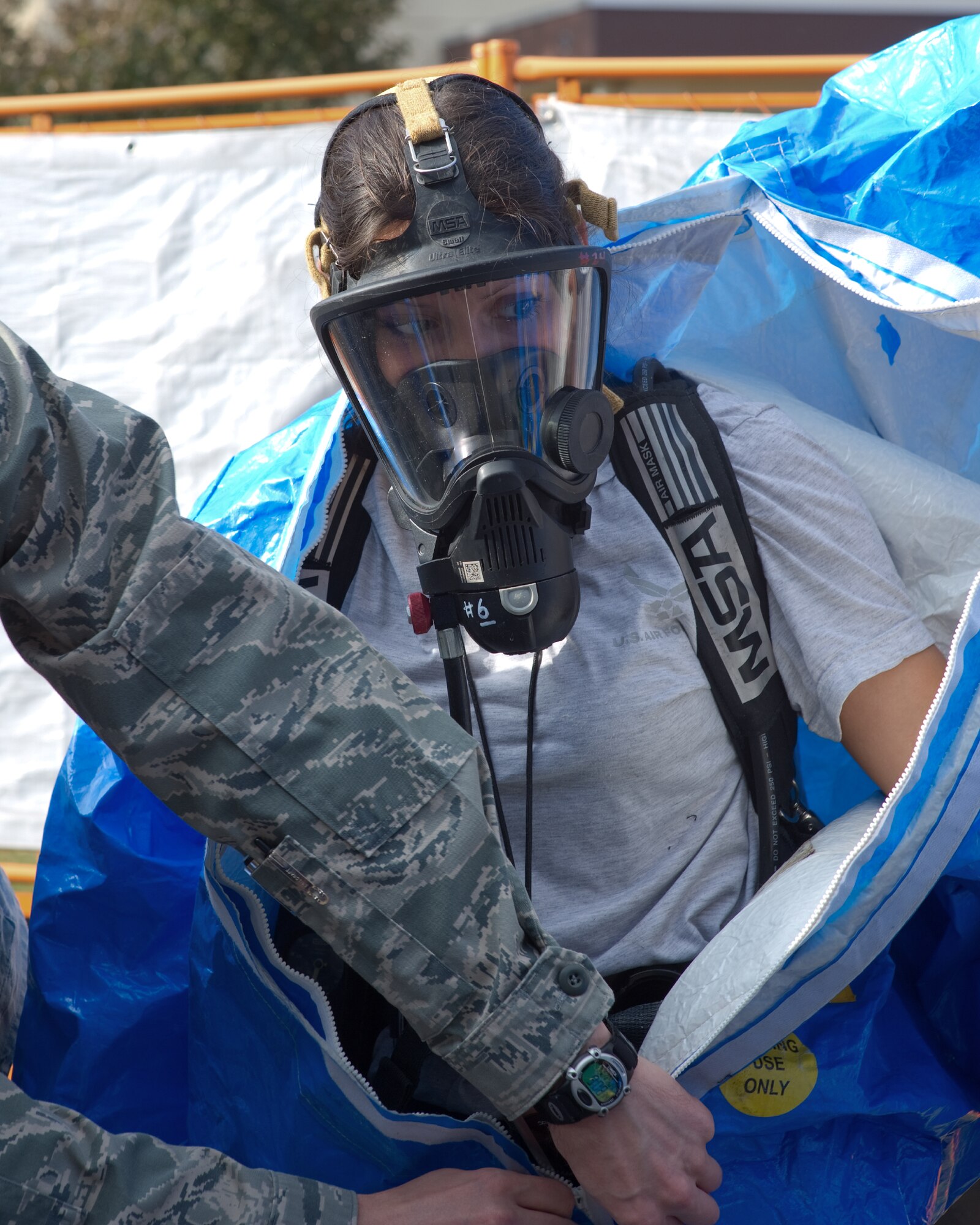 YOKOTA AIR BASE, Japan -- Senior Airman Kristina Ramos, 374th Civil Engineer
Squadron emergency management journeyman, removes a chemical suit after
completing an initial response scenario during a medical counter-chemical, biological, radiological and nuclear exercise at Yokota Air Base, Japan, Nov. 4, 2011. The training experience is valuable to Airmen because it tests their knowledge on how to identify and react to CBRN agents. (U.S. Air Force photo/Osakabe Yasuo)
