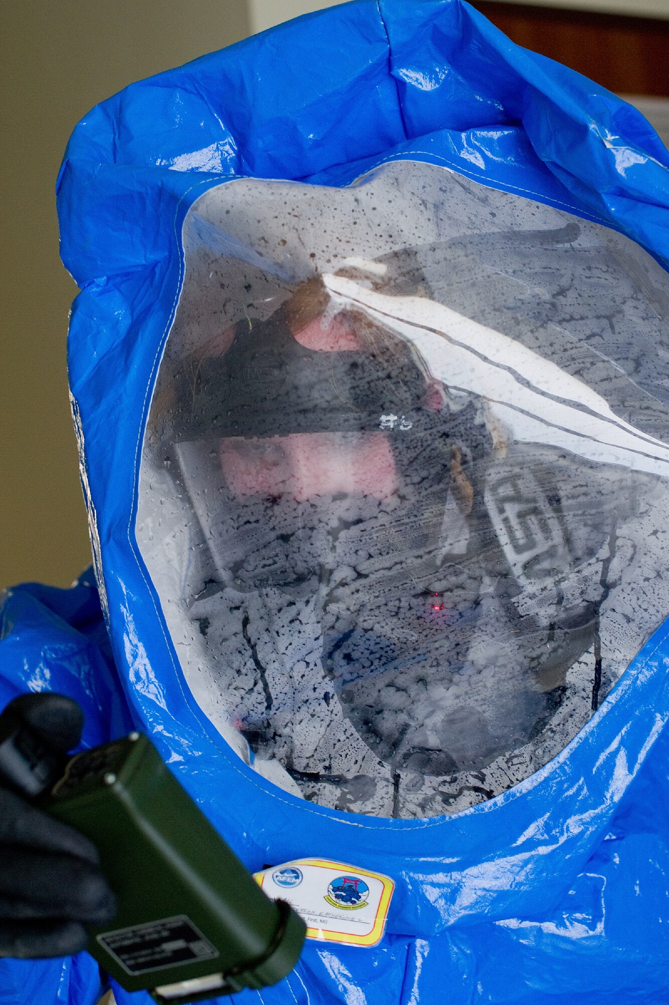 YOKOTA AIR BASE, Japan -- Senior Airman Katherine Anderson, 374th Civil Engineer Squadron emergency management journeyman, checks a joint chemical agent detector during a medical counter-chemical, biological, radiological and nuclear exercise scenario at Yokota Air Base, Japan, Nov. 4, 2011. The training experience is valuable to Airmen because it tests their knowledge on how to identify and react to CBRN. (U.S. Air Force photo/Osakabe Yasuo)