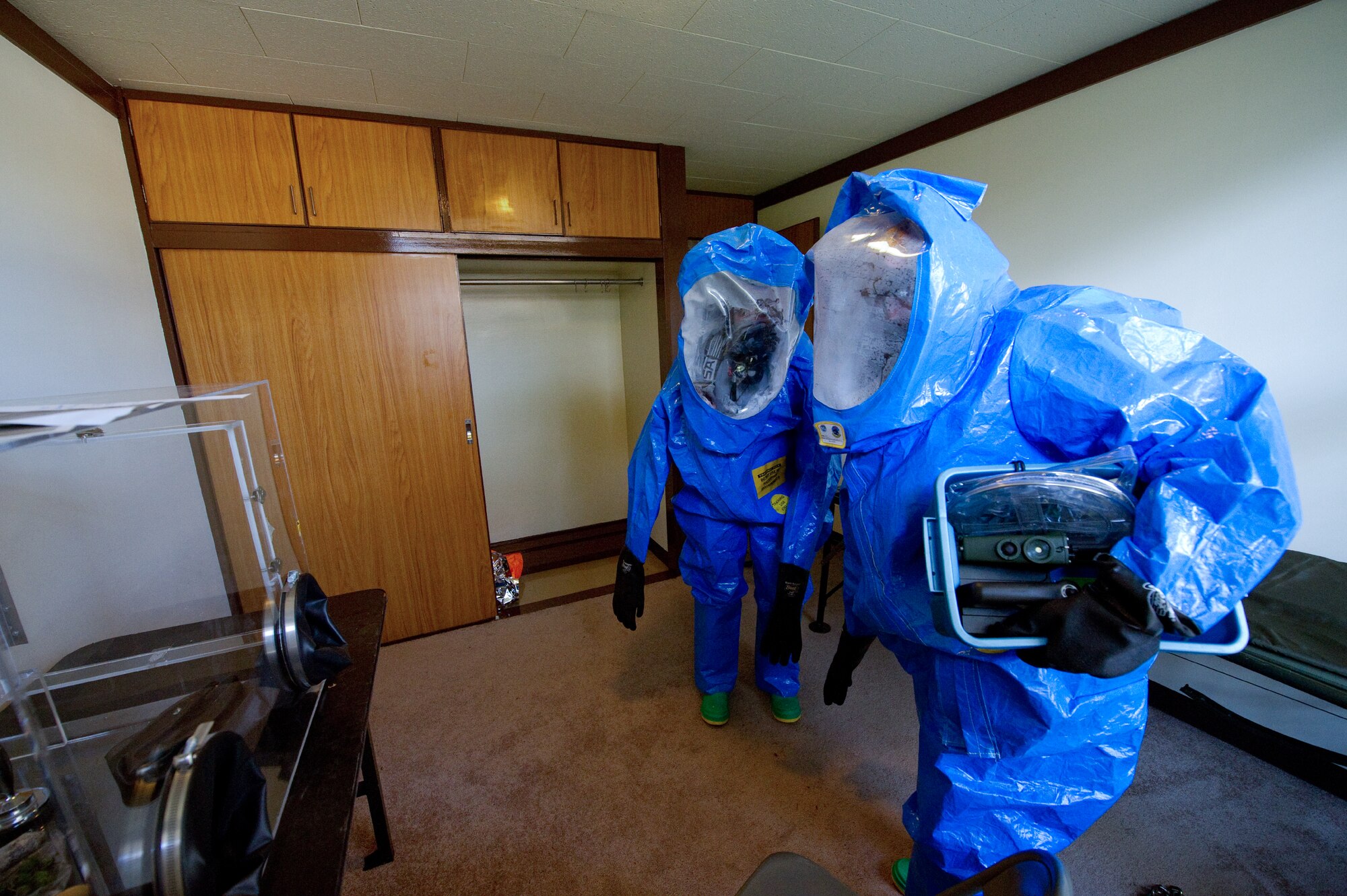 YOKOTA AIR BASE, Japan -- Senior Airman Kristina Ramos and Senior Airman Katherine Anderson, both 374th Civil Engineer Squadron emergency management journeymen, perform an inspection on a simulated contaminated house as part of a medical counter-chemical, biological, radiological and nuclear exercise scenario at Yokota Air Base, Japan, Nov. 4, 2011. The training experience is valuable to Airmen because it tests their knowledge on how to identify and react to CBRN agents. (U.S. Air Force photo/Osakabe Yasuo)