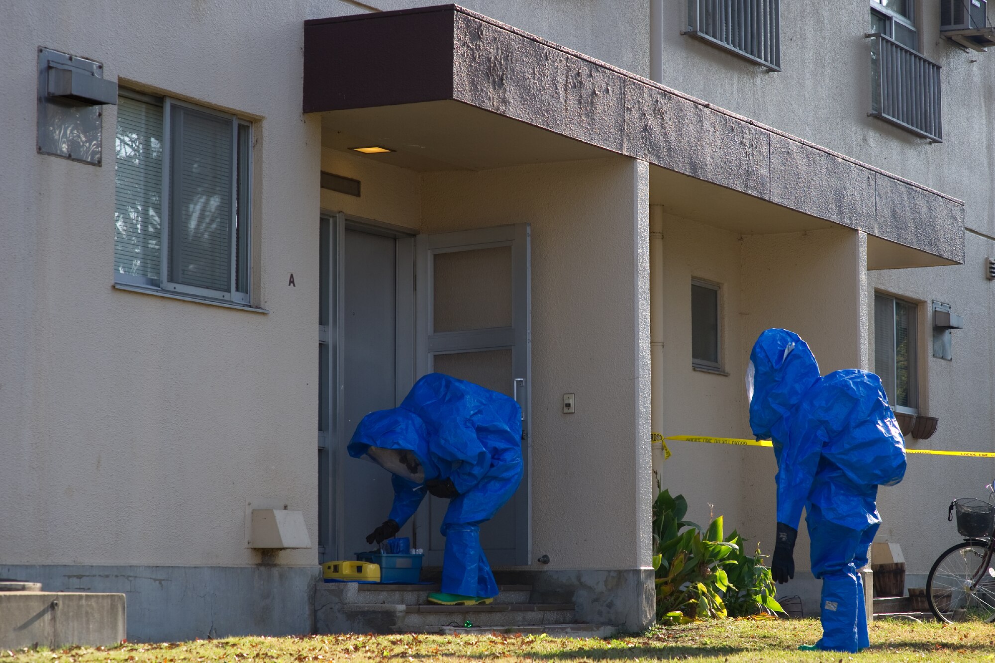 YOKOTA AIR BASE, Japan -- Airmen from the 374th Civil Engineer Squadron perform an inspection on a simulated contaminated house as part of a medical counter-chemical, biological, radiological and nuclear exercise scenario at Yokota Air Base, Japan, Nov. 4, 2011. The training experience is valuable to Airmen because it tests their knowledge on how to identify and react to CBRN agents. (U.S. Air Force photo/Osakabe Yasuo)