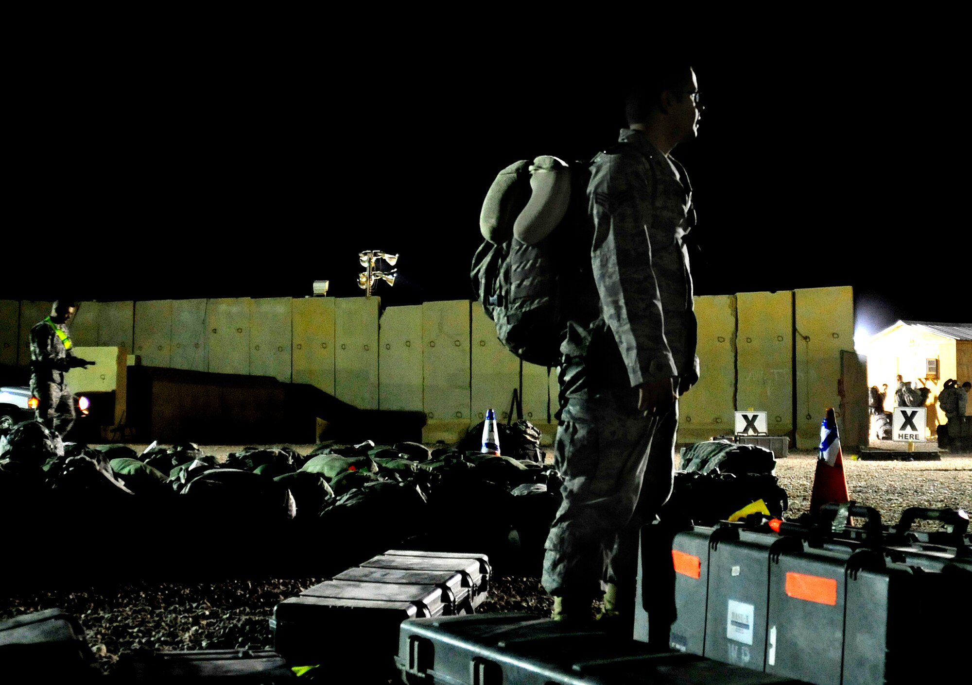 Senior Airman Kristian Robles Cruz, who was deployed with the 332nd Expeditionary Security Forces Squadron at Joint Base Balad, Iraq, gathers his bags at the Al Asad Air Base Passenger Terminal in Iraq prior to departing for the U.S. on Nov. 1, 2011. Airman Cruz is assigned to the 633rd Security Forces Squadron at Joint Base Langley-Eustis, Va. He deployed in support of Operation New Dawn and helped create a more stable, sovereign and self-reliant Iraq. The U.S. military is on track to honor its commitment to the U.S.-Iraq Security Agreement and redeploy the remaining 33,000 troops by Dec. 31, 2011.  At the height of the surge in 2007, there were 165,000 U.S. troops in Iraq. This drawdown is one of the largest military operations since World War II.    (U.S. Air Force photo/Master Sgt. Cecilio Ricardo)