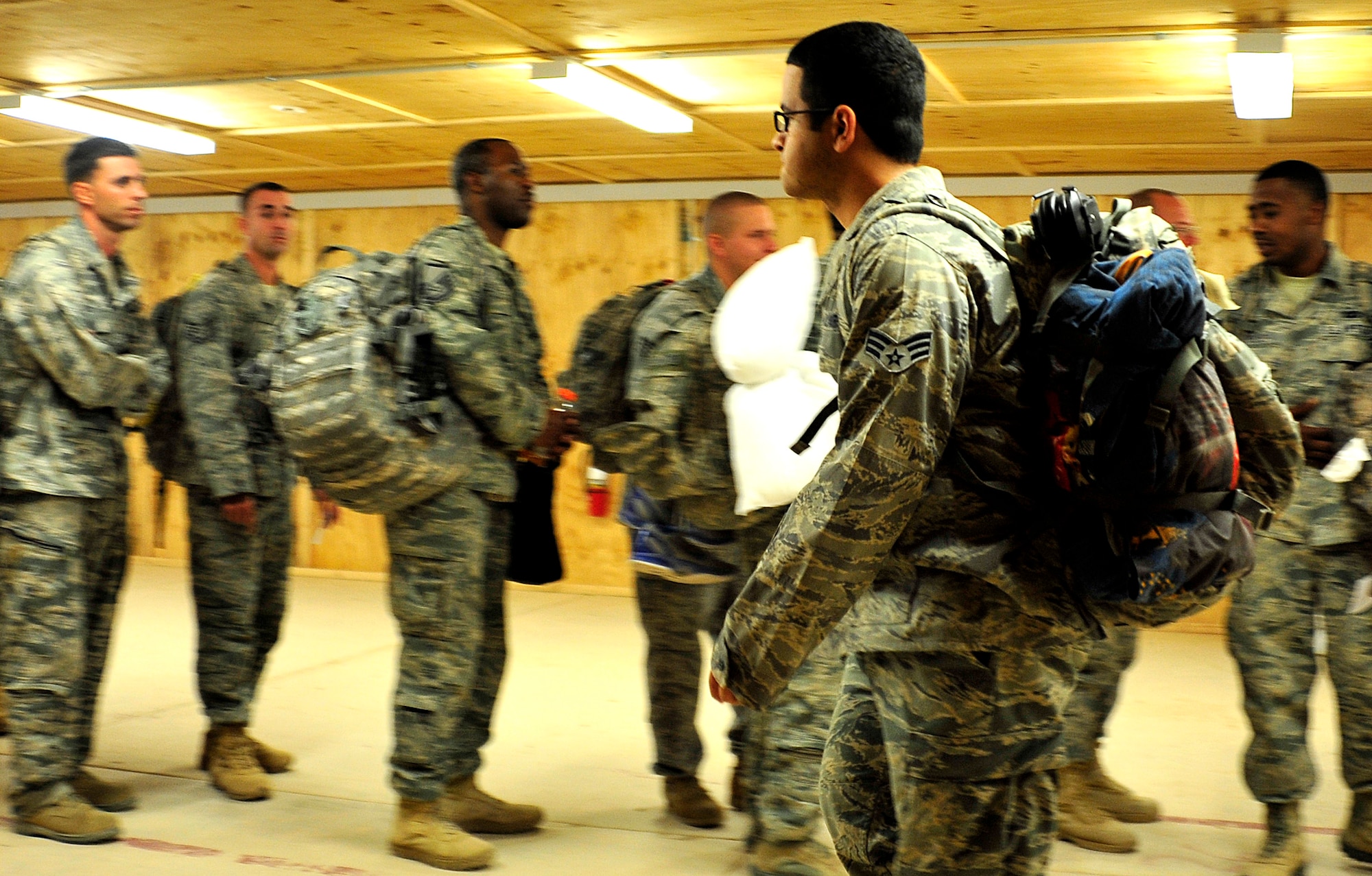 Senior Airman Kristian Robles Cruz processes through customs at the Al Asad Air Base Passenger Terminal in Iraq, prior to departing for the U.S. on Nov. 1, 2011. He was deployed with the 332nd Expeditionary Security Forces Squadron at Joint Base Balad, Iraq, and is assigned to the 633rd Security Forces Squadron at Joint Base Langley-Eustis, Va. Airman Cruz and his fellow service members deployed in support of Operation New Dawn and helped create a more stable, sovereign and self-reliant Iraq. The U.S. military is on track to honor its commitment to the U.S.-Iraq Security Agreement and redeploy the remaining 33,000 troops by Dec. 31, 2011. At the height of the surge in 2007, there were 165,000 U.S. troops in Iraq. This drawdown is one of the largest military operations since World War II. (U.S. Air Force photo/Master Sgt. Cecilio Ricardo)
