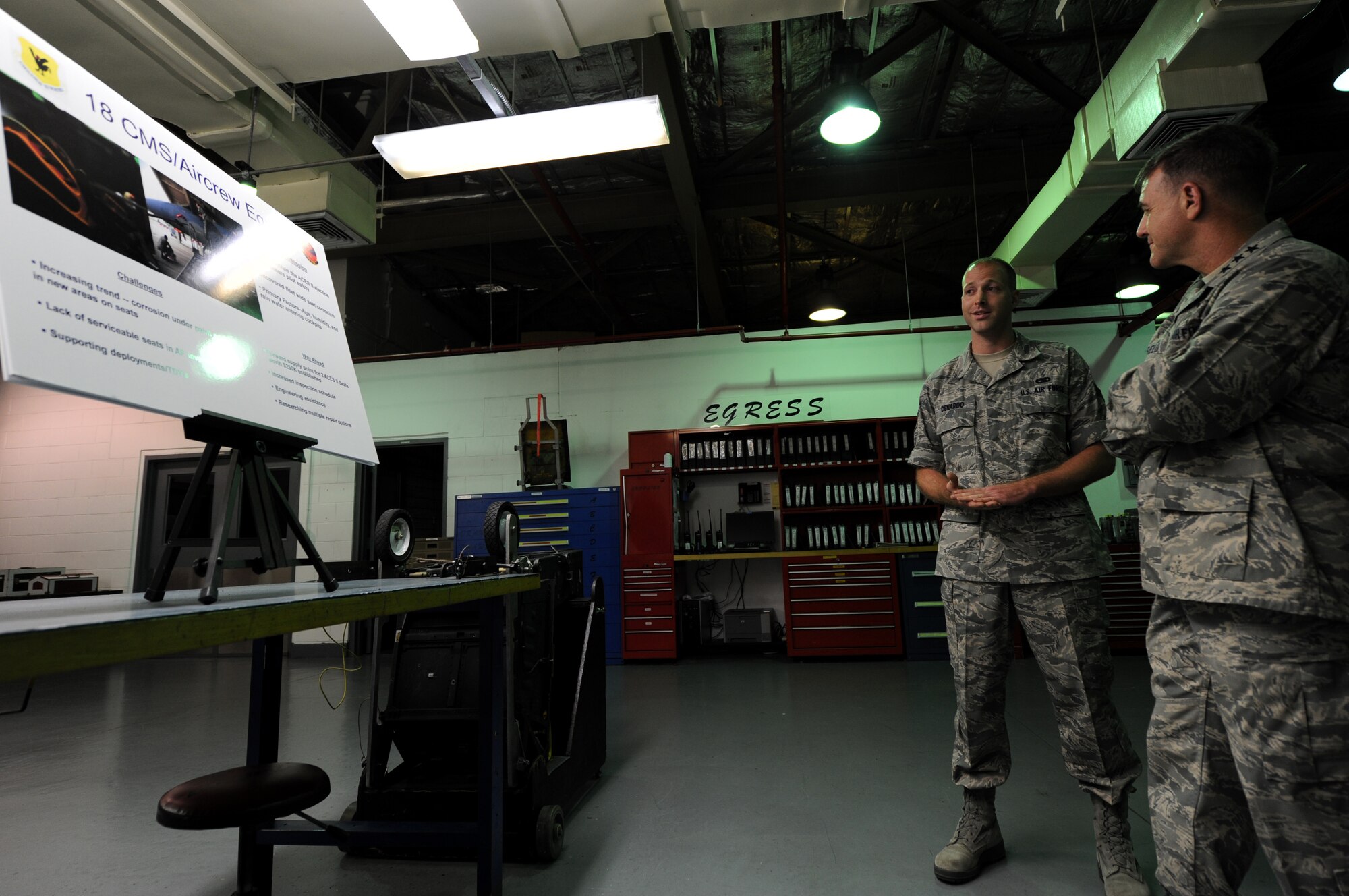 U.S. Air Force Senior Airman Paul Denardo, 18th Component Maintenance Squadron aircrew egress journeyman, briefs Lt. Gen. Burt Field, U.S. Forces Japan and 5th Air Force commander, on preventative maintenance techniques and procedures which are performed on the U.S. Air Force F-15 Eagles on Kadena Air Base, Japan, Nov. 4. Field attended the 12th annual Kadena Special Olympics, visited several units around the base and shared key messages with Airmen during his visit to Kadena. (U.S. Air Force photo/ Senior Airman Jarvie Z. Wallace/Released)
