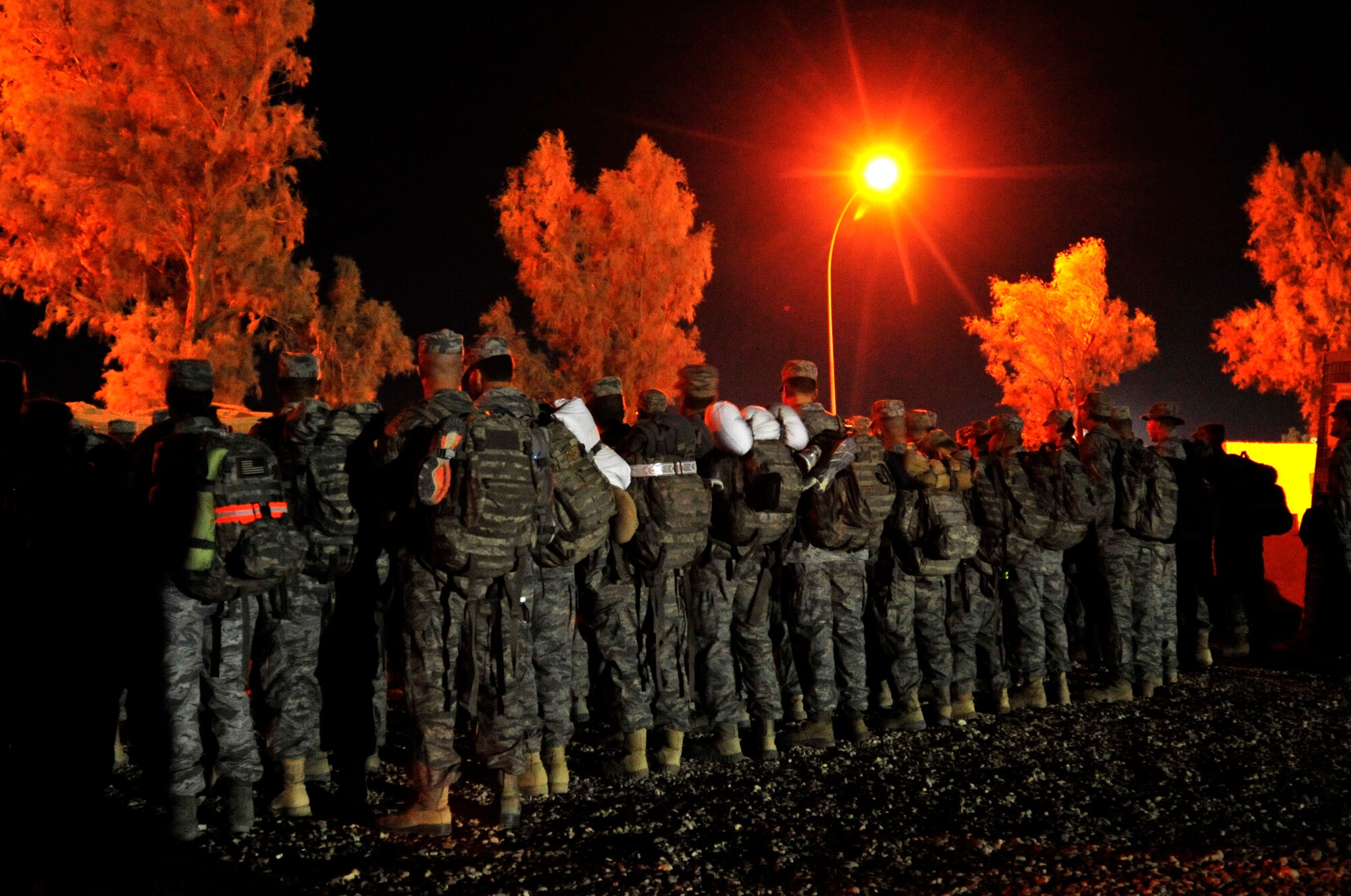 U.S. service members gather early in the morning on Nov. 1, 2011, near their tents in Iraq to begin their journey to the U.S.  The group was deployed in support of Operation New Dawn and helped create a more stable, sovereign and self-reliant Iraq. The U.S. military is on track to honor its commitment to the U.S.-Iraq Security Agreement and redeploy the remaining 33,000 troops by Dec. 31, 2011. At the height of the surge in 2007, there were 165,000 U.S. troops in Iraq. This drawdown is one of the largest military operations since World War II.  (U.S. Air Force photo/Master Sgt. Cecilio Ricardo)