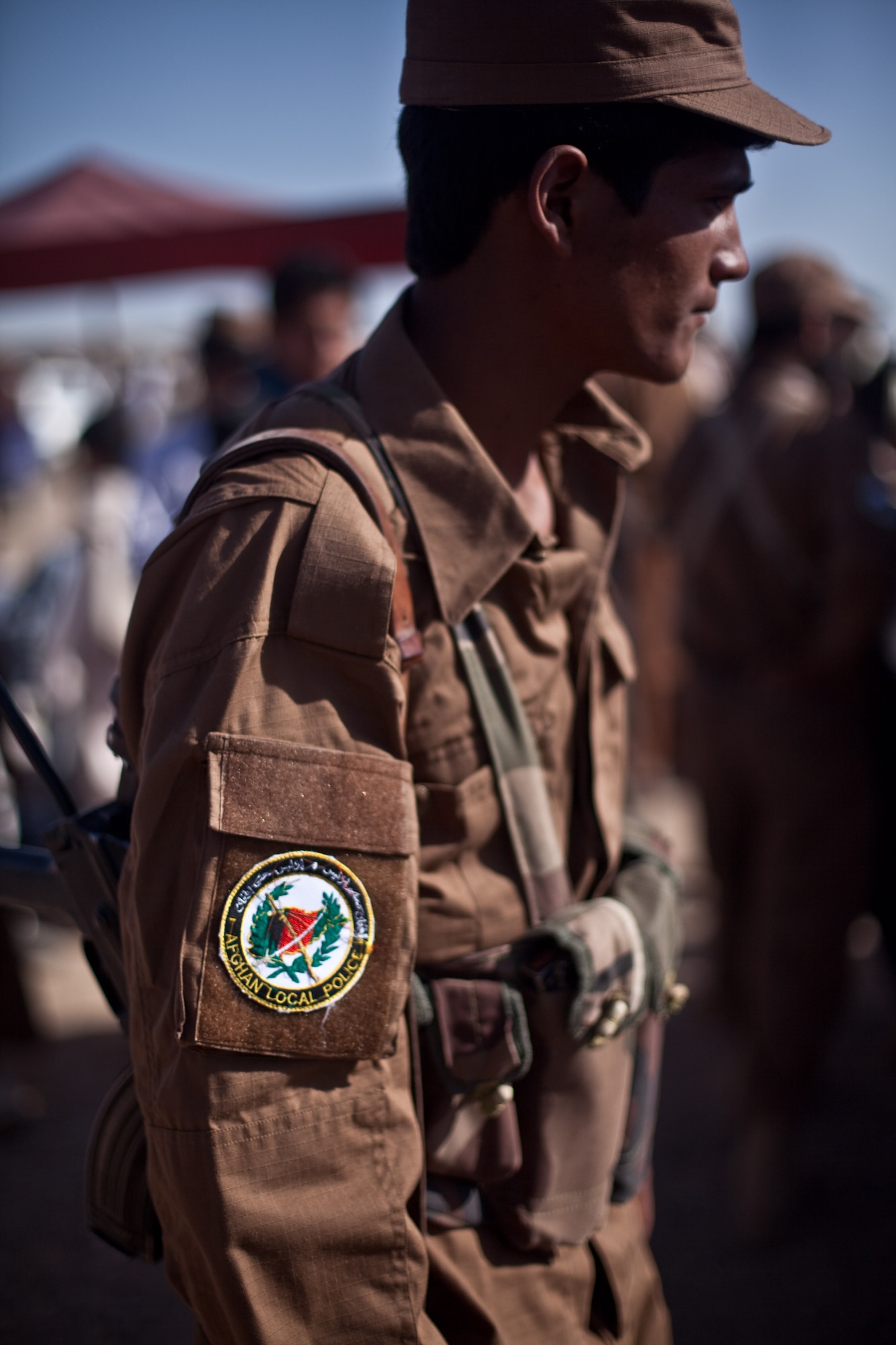 Members of the Afghan Local Police patrol a local bazaar. The local policemen conducted the patrol to engage local citizens and address issues of security and governance. (Photo by Spc. Jeff Collet)

