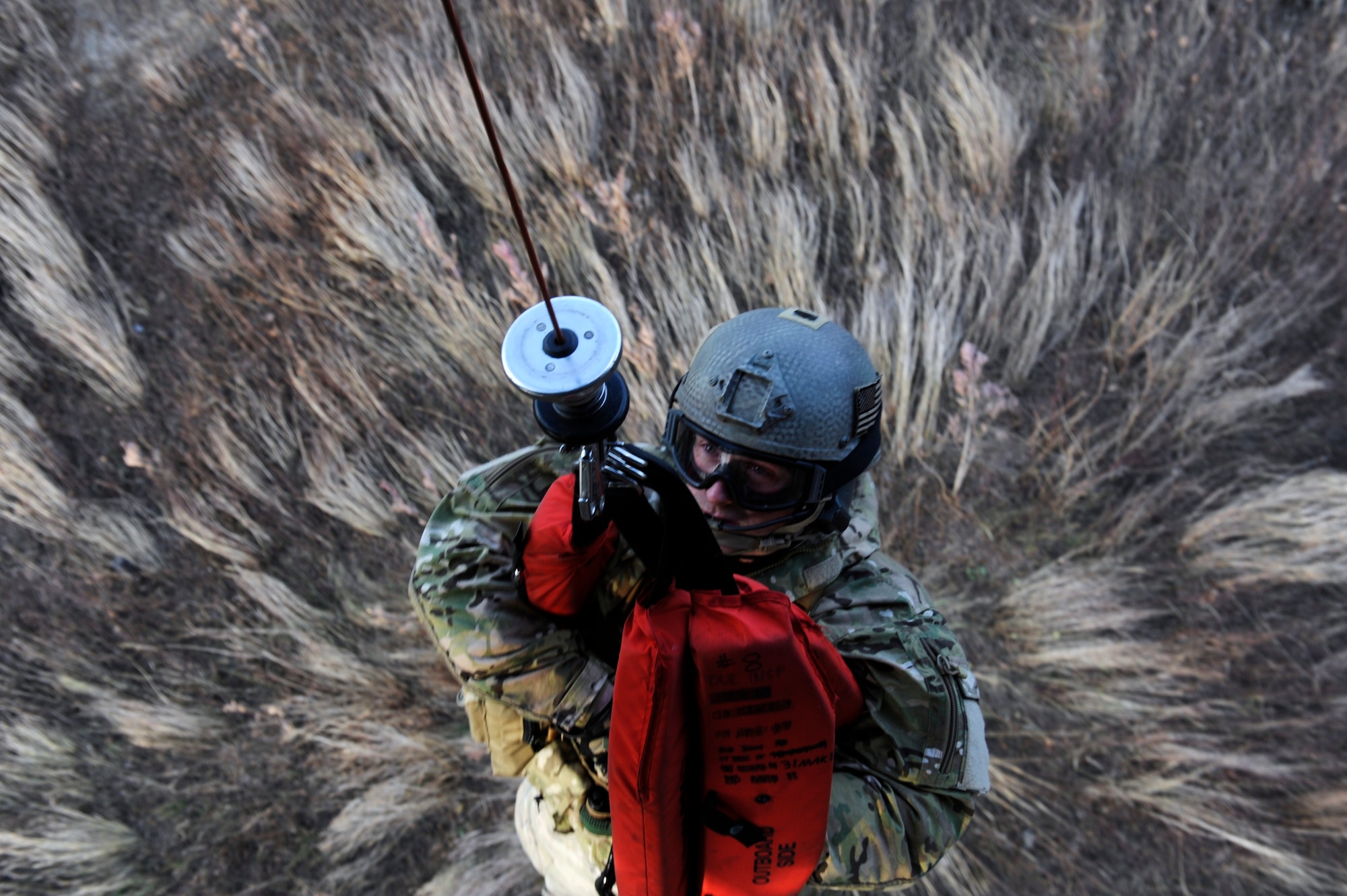 U.S. Air Force Staff Sgt. Robert Colliton, Survival Evasion Resistance Escape specialist from the 18th Operation Support Squadron on Kadena Air Base, Japan, is hoisted up to a rescue helicopter during exercise PACIFIC THUNDER Nov. 3 near Osan Air Base, Republic of Korea.
PACIFIC THUNDER is a 10-day exercise from Oct. 31 to Nov. 9 at Osan AB. The exercise involves the 33rd Rescue Squadron from Kadena AB, Japan, and the 25th Fighter Squadron from Osan. These units work together to practice combat search and rescue tactics to prepare for real-world emergency situations. (U.S. Air Force photo/Tech. Sgt. Angelique Bilog/released)
