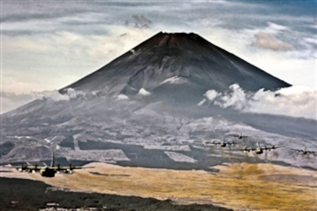 A formation of C-130 Hercules cargo aircraft fly in formation during a Samurai Surge training mission near Mount Fuji, Japan, Nov. 2, 2011. The 374th Airlift Wing uses C-130s to perform intra-theater airlift missions in the western Pacific region.