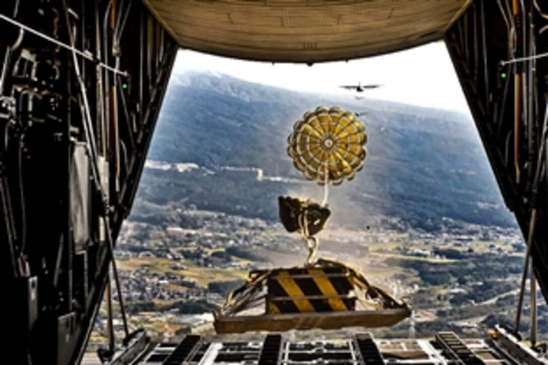 A heavy payload deploys from the rear ramp of a C-130 Hercules aircraft during Samurai Surge near Mount Fuji, Japan, Nov. 2, 2011. Aircrew members assigned to the 36th Airlift Squadron participated in Samurai Surge, an all-day training exercise testing mission capability of many agencies throughout the base.
