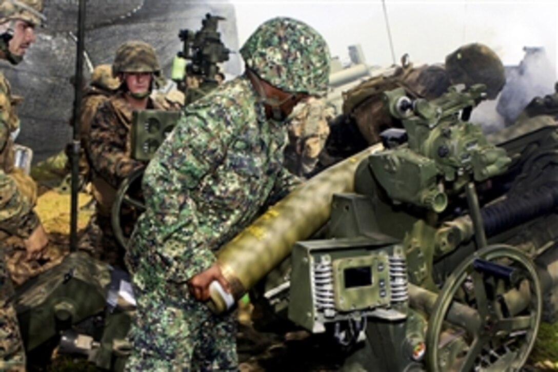 U.S. and Philippine Marines load M107 high explosive rounds into an M777A2 howitzer during an artillery shoot on Fort Magsaysay, Philippines, Oct. 25, 2011. The Marines are assigned to 2nd Battalion, 7th Marines, 31st Marine Expeditionary Unit, and provided familiarization training on the M777A2 howitzer as a part of Philippines-U.S. Amphibious Landing Exercise 2012.