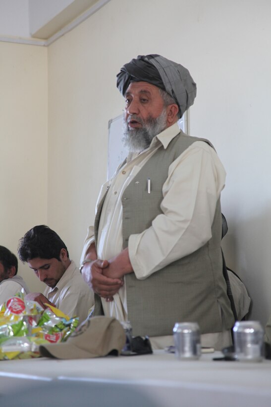 Nawa District Governor Abdul Manaf addresses a group of local residents during a shura he hosted here, Oct. 29.  Manaf highlighted plans for Nawa's future, emphasizing his enduring objectives of peace, poppy eradication, eradication and security.