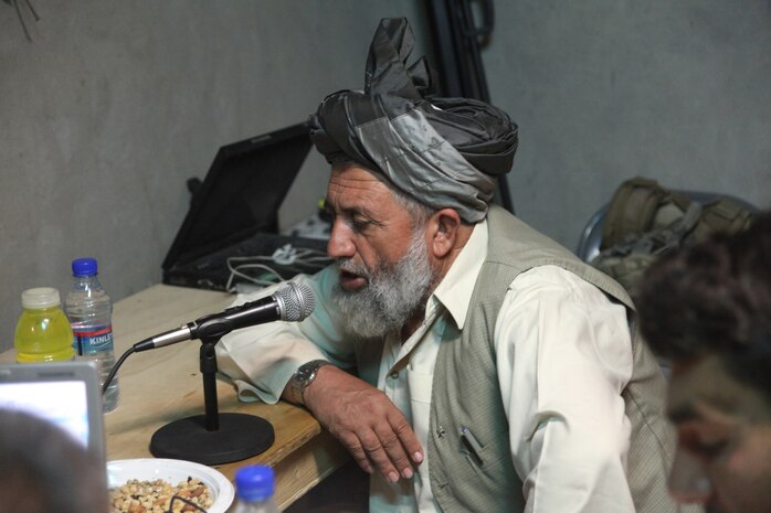 Nawa District Governor Abdul Manaf speaks with a caller during a live radio show here, Oct. 29.  Manaf highlighted plans for Nawa's future, emphasizing his enduring objectives of peace, poppy eradication, education and security.  He uses radio programs to reach those who are unable to attend the shuras he hosts throughout the district.