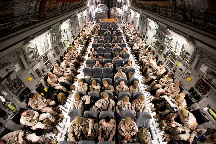Marines and sailors with Headquarters and Service Company, 3rd Battalion, 3rd Marine Regiment, sit aboard an Air Force C-130 transport aircraft on the flight line of Manas Air Force Base, Kyrgyztan, before departing for Camp Dwyer, Afghanistan, Oct. 30, 2011. After departing home in Hawaii from Oct. 27 through Nov. 1, the Marines and sailors of “America’s Battalion” arrived in Afghanistan’s Helmand province to begin their seven-month deployment in support of Regimental Combat Team 5. They are filtering into the province’s Garmsir District to relieve fellow Hawaii-based 1st Battalion, 3rd Marine Regiment, who arrived here in April. (Official U.S. Marine Corps photo by Cpl. Reece Lodder / RELEASED)