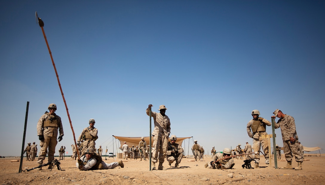 Cpl. Sebastian Chenault, an anti-tank missileman, and Pvt. Beau Babcock, a mortarman with Jump Platoon, Headquarters and Service Company, 3rd Battalion, 3rd Marine Regiment, use bamboo sticks called “sickle sticks” to locate the wires of mock improvised explosive devices during counter-IED training on Camp Dwyer, Afghanistan, Nov. 3, 2011. After departing home in Hawaii from Oct. 27 through Nov. 1, the Marines and sailors of “America’s Battalion” arrived in Afghanistan’s Helmand province to begin their seven-month deployment in support of Regimental Combat Team 5. They are filtering into the province’s Garmsir District to relieve fellow Hawaii-based 1st Battalion, 3rd Marine Regiment, who arrived here in April. Chenault, 27, is from Lacon, Ill. Babcock, 20, is from Dallas. (Official U.S. Marine Corps photo by Cpl. Reece Lodder / RELEASED)