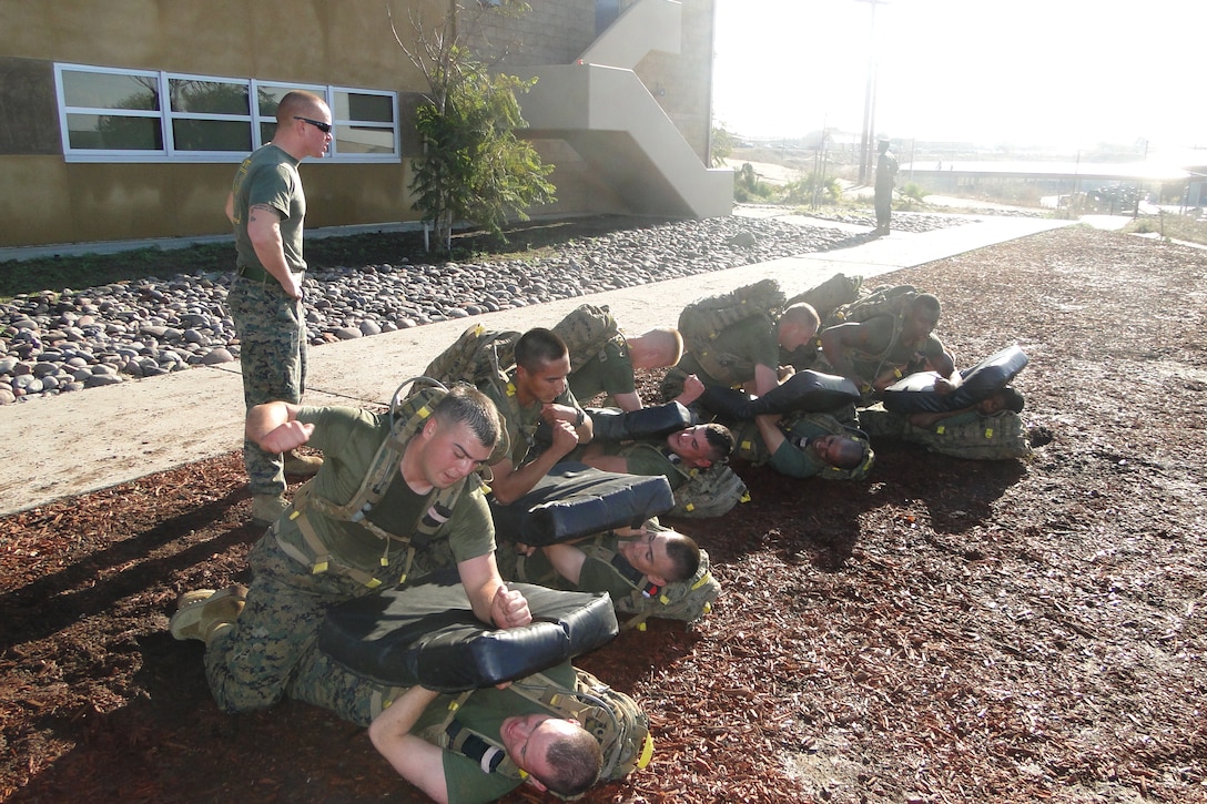Sgt Andrew Cohen overlooks as students PT, using fundamentals of MCMAP.