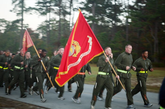 Marines and sailor with the 2nd Marine Logistics Group hit the pavement during the 2nd MLG Marine Corps Birthday run aboard Camp Lejeune, N.C., Nov. 8, 2011. The run was in honor of the Corps’ 236th birthday and was followed by a traditional cake-cutting ceremony at Soifert Field. (U.S. Marine Corps photo by. Pfc. Franklin E. Mercado)