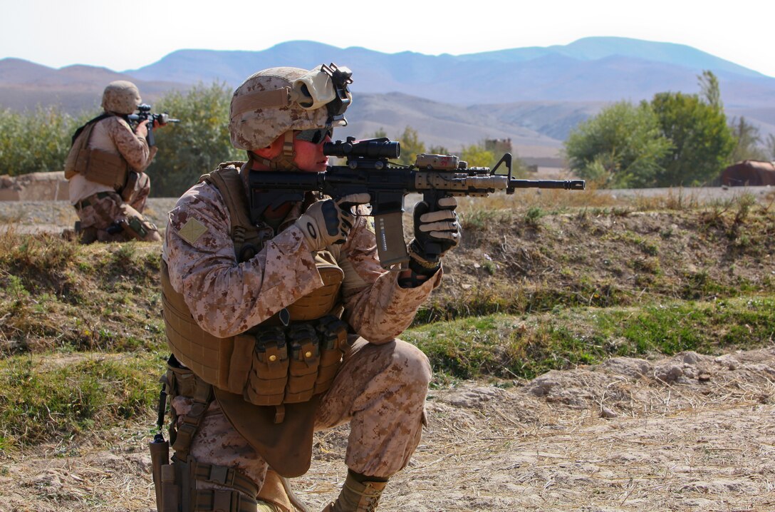 Staff Sgt. Jason Browning, a Bowie, Md., native and operations chief for Embedded Partnering Team, 2nd Marine Logistics Group (Forward), scans the horizon through his rifle combat optic after dismounting during a week-long convoy from Kabul, Oct. 30. The EPT escorted more than 30 vehicles carrying soldiers from the Afghan National Army's 215th Corps Logistics Battalion to Camp Shorabak in Helmand province.