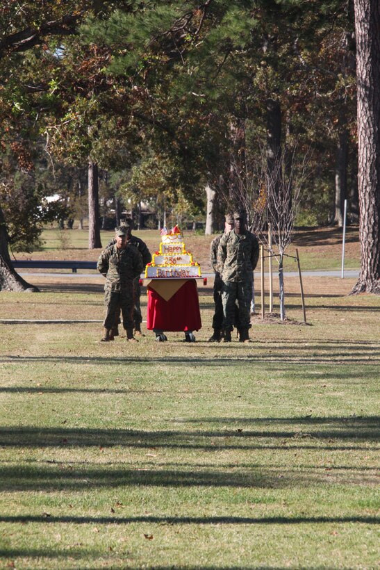 Four Marines stand ready to escort a birthday cake during the Marine Corps Air Station Cherry Point 236th Marine Corps Birthday Cake-cutting Ceremony and Historical Uniform Pageant in front of the Christian F. Schilt building Nov. 8. As part of the Marine Corps tradition, the cake was cut and the first piece went to the oldest Marine present and the next one was given to the youngest Marine.