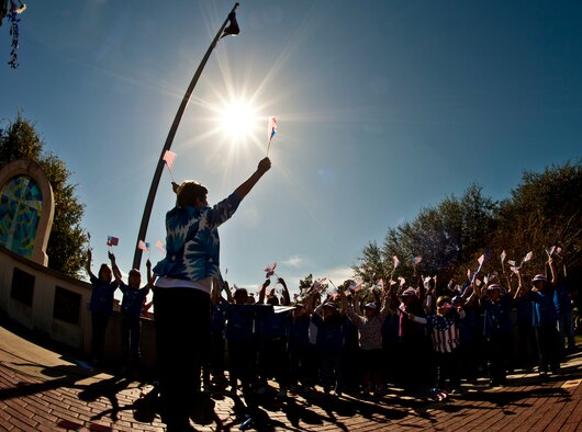 An Eglin Elementary School teacher leads students in a performance of "Stars and Stripes Forever" during a Veterans Day ceremony at the All Wars Memorial at Eglin Air Force Base, Fla., Nov. 8. More than 400 students attended the ceremony.  (U.S. Air Force photo/Sachel Seabrook)