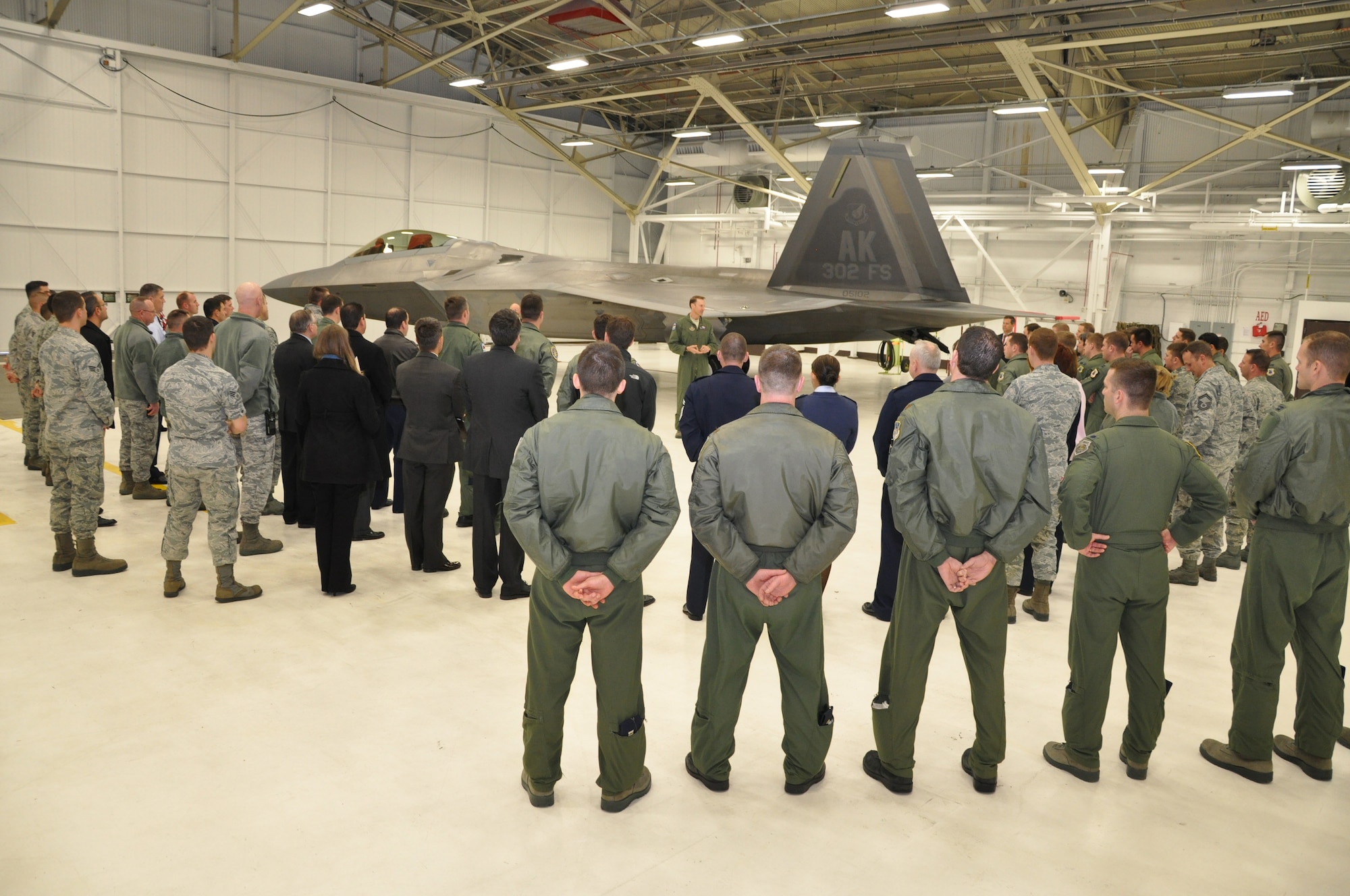 Lt. Col. David Piffarerio, 302nd Fighter Squadron commander, spoke to a crowd of active duty and Reserve pilots and maintainers after being presented Lockheed-Martin’s 1,000 hour patch during a ceremony here Nov. 7. Piffarerio flew the 1,000 hour flight Nov. 4.