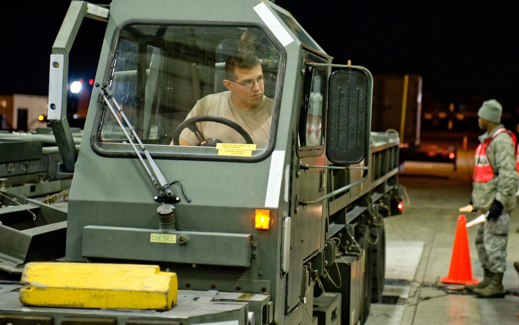 YOKOTA AIR BASE, Japan -- Staff Sgt. Rolando Rivera, 374th Logistics Readiness Squadron small air terminal assistant, backs up a truck carrying equipment onto a scale at Yokota Air Base, Japan, Nov. 9, 2011. Airmen from the 374th LRS must weigh items prior to transporting and storing them to ensure the proper shipment of equipment. (U.S. Air Force photo/Airman John D. Partlow)