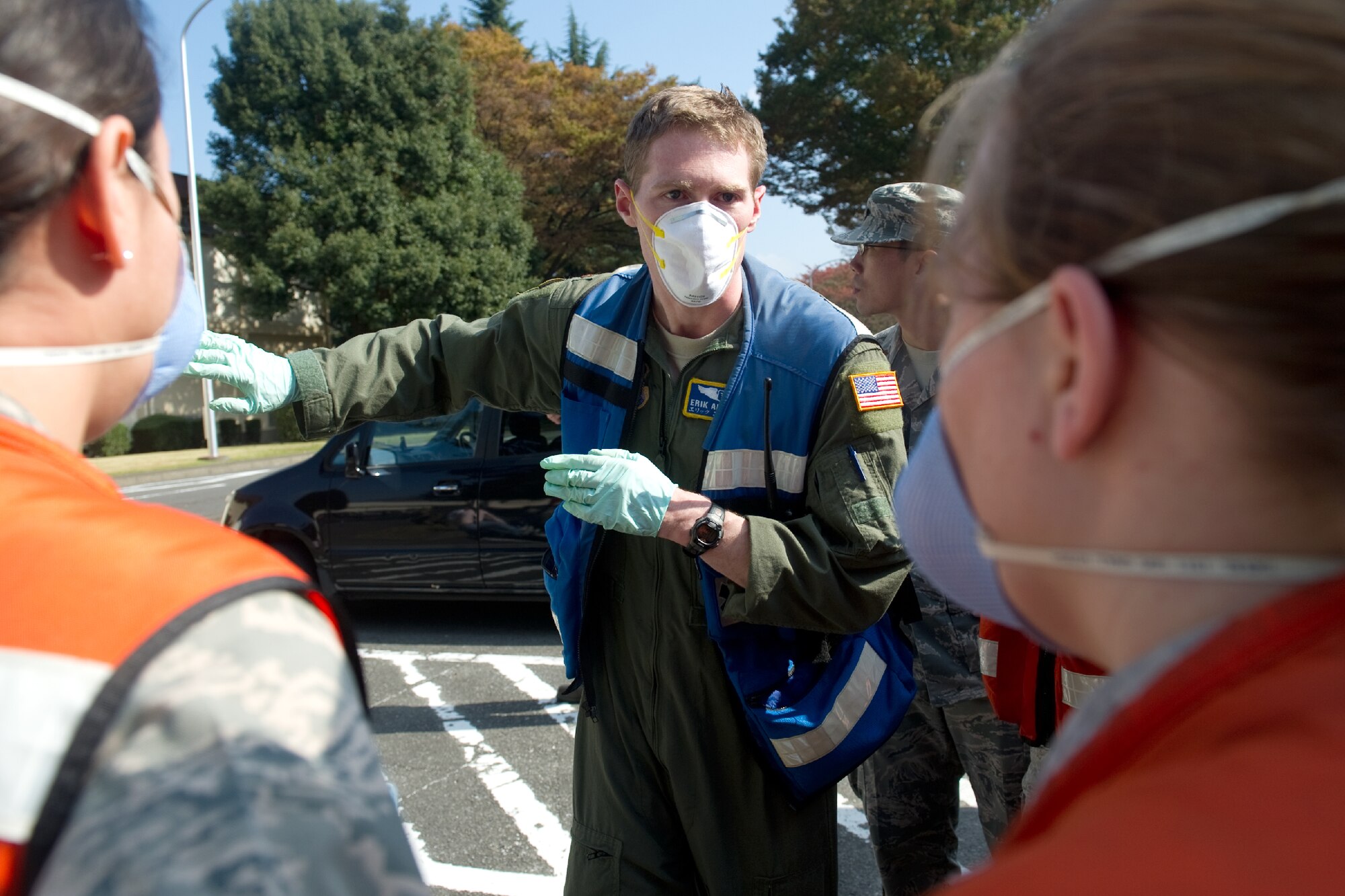 YOKOTA AIR BASE, Japan -- Major Erik Abrames, 374th Aerospace Medicine Squadron flight surgeon, directs members of 374th AMDS field response team during a medical counter-chemical, biological, radiological and nuclear exercise scenario at Yokota Air Base, Japan, Nov. 4, 2011. The training experience is valuable to Airmen because it tests their knowledge and ability to identify and react to CBRN agents. (U.S. Air Force photo/Osakabe Yasuo)