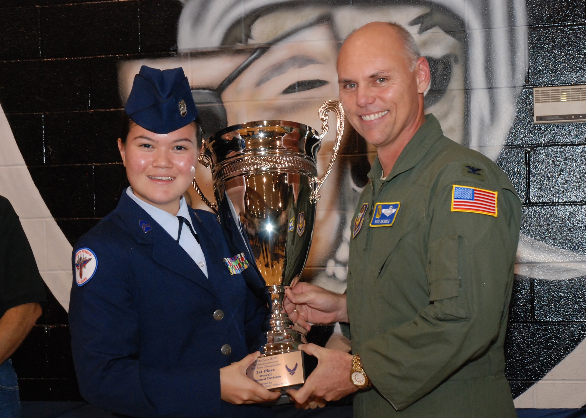 A Jeffereson High School Air Force JROTC cadet accepts the 1st Place Overall Unarmed Division Trophy from Col. Richard Kemble, 94th Airlift Wing vice commander, at the conclusion of the Southern Invitational Drill Team Championship at East Paulding High School Nov. 5. (U.S. Air Foce photo/Master Sgt. Stan Coleman)