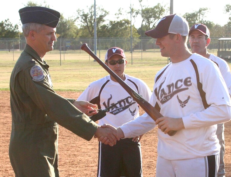 Col. Kurt Meidel, left, the 71st Flying Training Wing vice commander, presents a new Louisville Slugger to Capt. John Stock, captain of the winning team in the 2011 Combined Federal Campaign softball tournament held Oct. 28 at Vance Air Force Base, Okla. Five teams played in the tournament, which raised more than $470 dollars for CFC. Stock is assigned to the 71st Operations Support Squadron. (Courtesy photo)