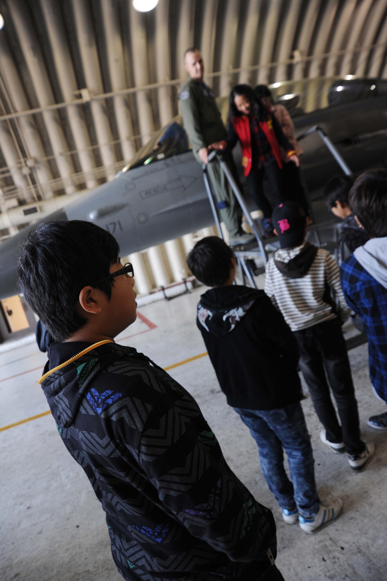 Students participating in the 8th Fighter Wing Honorary Pilot Program stand in line to take a look at the cockpit of an F-16 Fighting Falcon at Kunsan Air Base, Republic of Korea, Nov. 4, 2011. Several base agencies came together to put this program in motion. These agencies were: 35th Fighter Squadron, 35th Aircraft Maintenance Unit, 8th Operations Support Squadron aircrew flight equipment and tower operations and 8th FW public affairs community relations. (U.S. Air Force photo by Senior Airman Brittany Y. Auld/Released)
