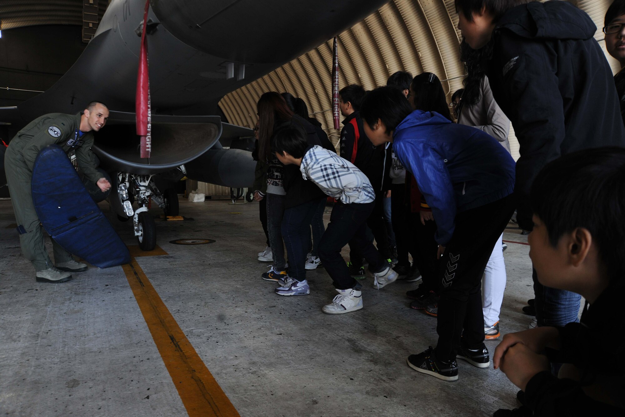 1st Lt. Shayne Carroll, 35th Fighter Squadron pilot, gives students participating in the 8th Fighter Wing Honorary Pilot Program a tour of an F-16 Fighting Falcon at Kunsan Air Base, Republic of Korea, Nov. 4, 2011. The program gave students a glance of what an F-16 pilot?s life is like here at Kunsan. They were able to receive a tour of an F-16 static display, F-35 Lighting II simulation, tour of the base tower, tower simulation, 35th Fighter Squadron tour and participated in hands on activities. (U.S. Air Force photo by Senior Airman Brittany Y. Auld/Released)
