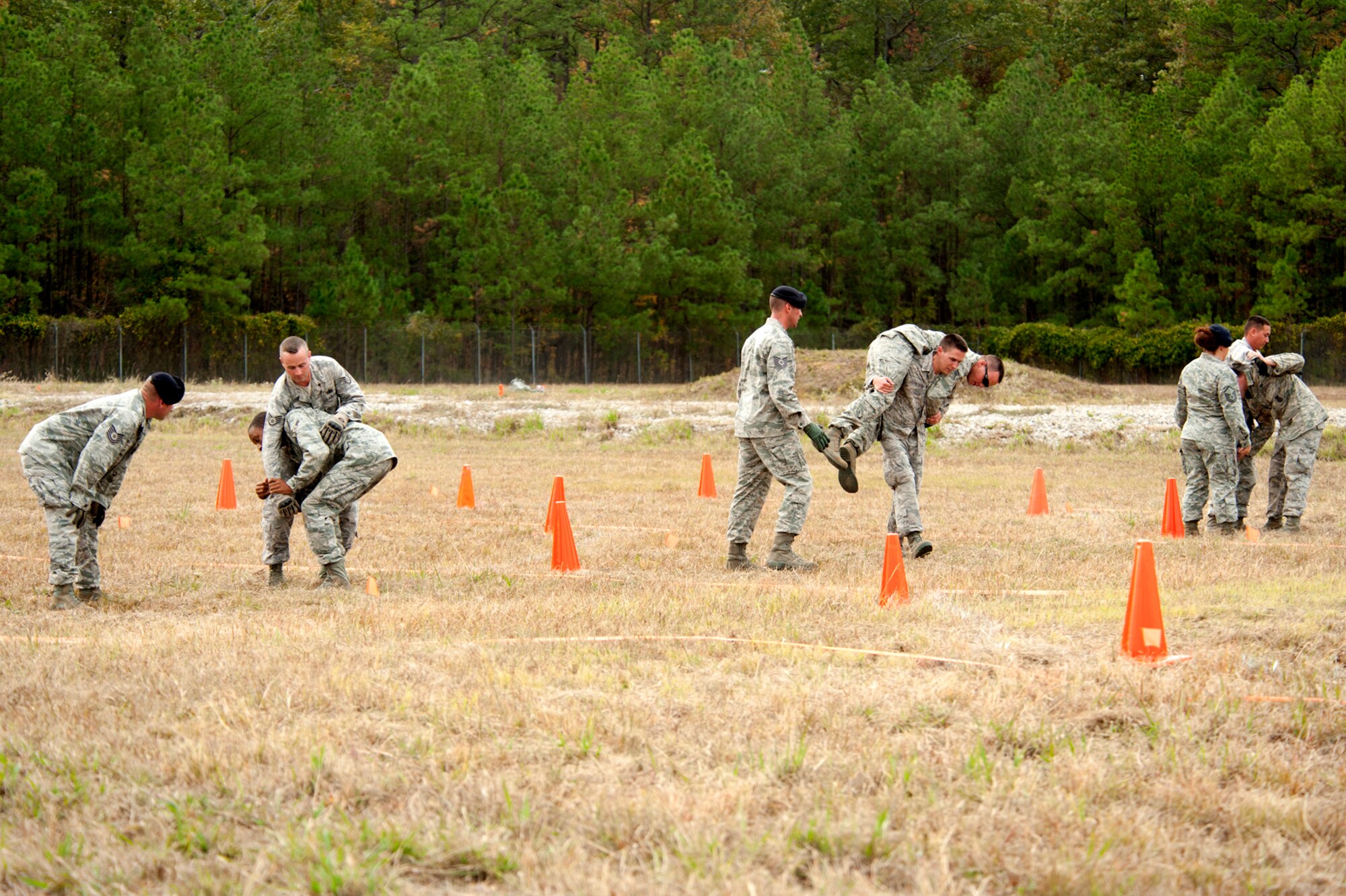 Members of the 307th Security Forces Squadron are tasked with carrying their teammates as part of the Mental and Physical (MAP) competition during the Global Strike Challenge, Barksdale Air Force Base, La., Nov. 7, 2011. The MAP competition is a timed event and tested the logical and physical abilities of each security forces team participating in the event. (U.S. Air Force photo by Master Sgt. Greg Steele/Released)
