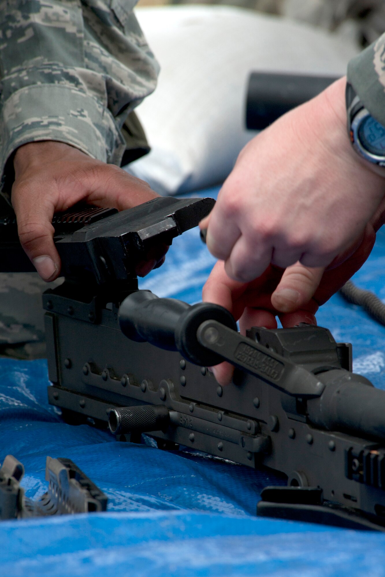 U.S. Air Force Airman 1st Class Stephen Boyd and Staff Sgt. James Casper, both assigned to the 307th Security Forces Squadron, work together to assemble an M60 machine gun as part of the Mental and Physical (MAP) competition during the Global Strike Challenge, Barksdale Air Force Base, La., Nov. 7, 2011. A variety of weapons were disassembled as part of this challenge, requiring teamwork and firearm knowledge for a successful assembly. (U.S. Air Force photo by Master Sgt. Greg Steele/Released)