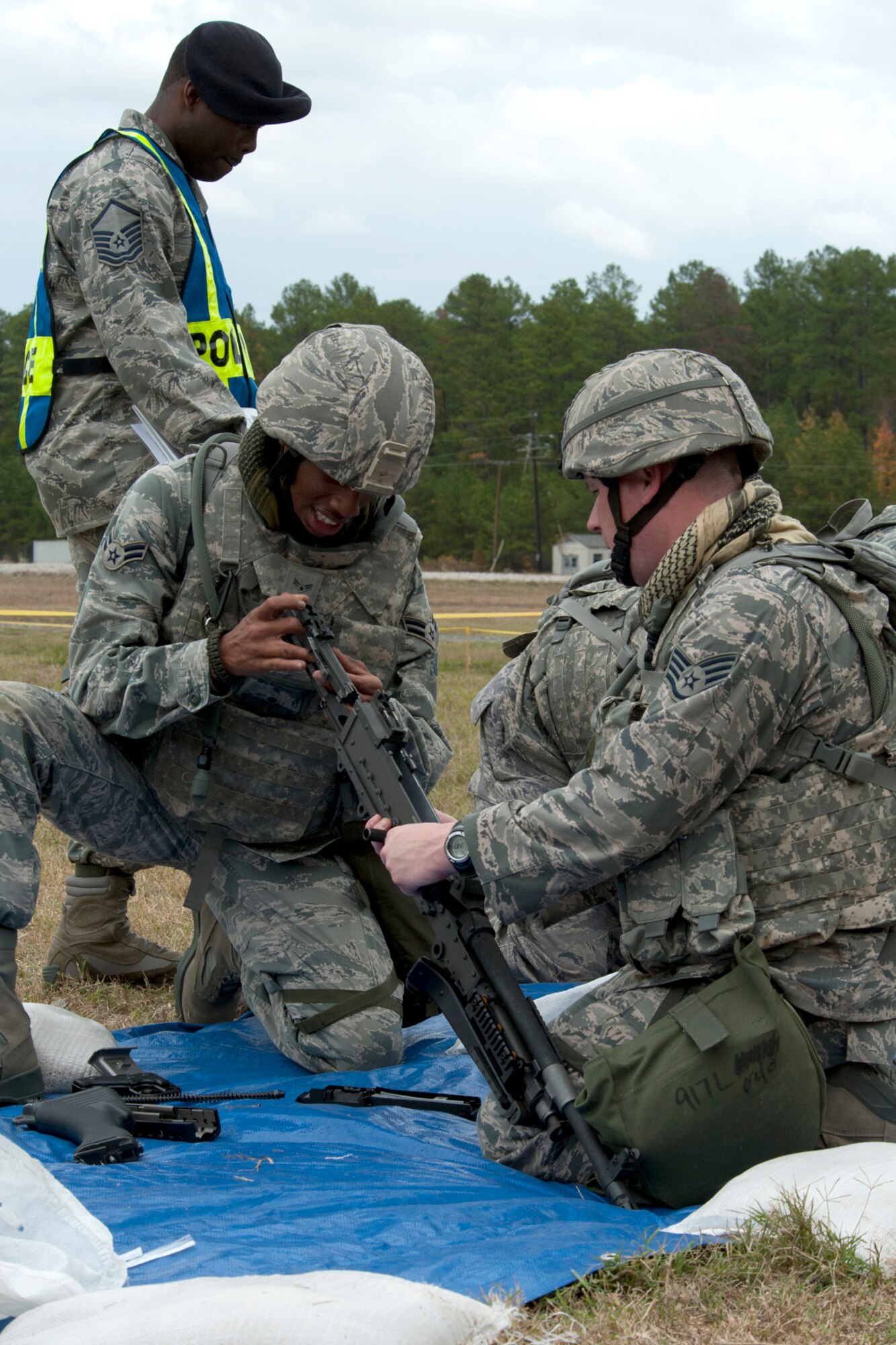 U.S. Air Force Airman 1st Class Stephen Boyd and Staff Sgt. James Casper, both assigned to the 307th Security Forces Squadron, work together to assemble an M60 machine gun as part of the Mental and Physical (MAP) competition during the Global Strike Challenge, Barksdale Air Force Base, La., Nov. 7, 2011. A variety of weapons were disassembled as part of this challenge, requiring teamwork and firearm knowledge for a successful assembly. (U.S. Air Force photo by Master Sgt. Greg Steele/Released)