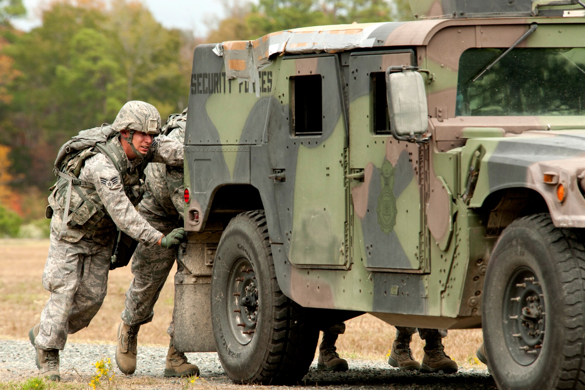 U.S. Air Force Senior Airman Timothy Cranston, 307th Security Forces Squadron, helps his teammates push a 12,500 pound Humvee during the Mental and Physical (MAP) competition during Global Strike Challenge, Barksdale Air Force Base, La., Nov. 7, 2011. The MAP competition is a timed event consisting of grueling physical and logic challenging scenarios for all security forces teams participating in the event. (U.S. Air Force photo by Master Sgt. Greg Steele/Released)