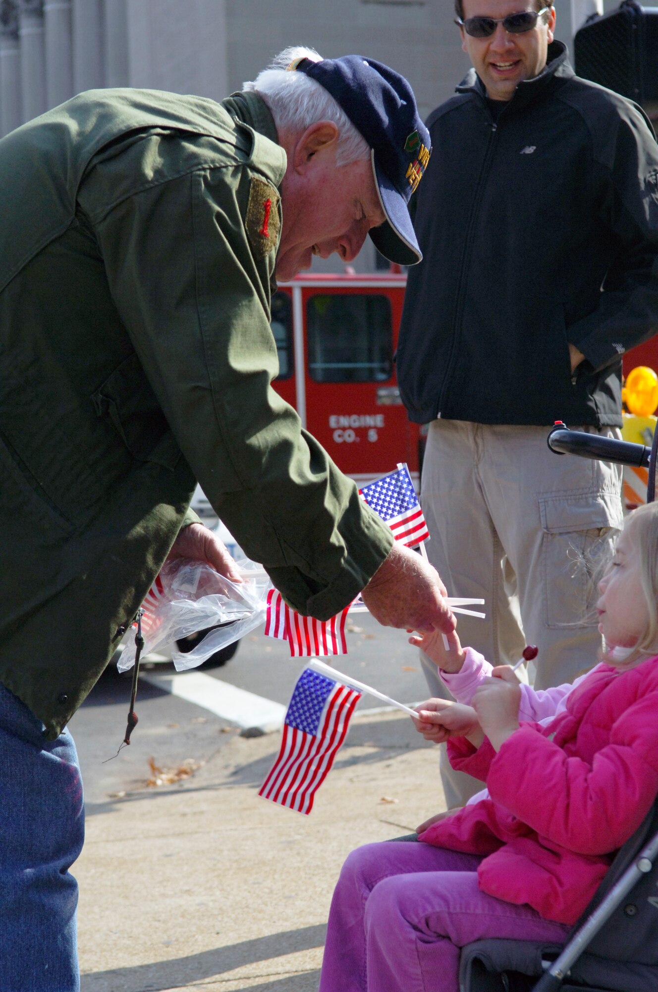 A participant of the Veteran?s Day parade gives children plastic American flags in honor of Veteran?s Day November 5, 2011 at St. Louis. Veteran?s Day was originally known as Armistice Day until legislation was passed to change its name on June 1, 1954. (U.S. Air Force photo/ Airman 1st Class Jake Eckhardt)