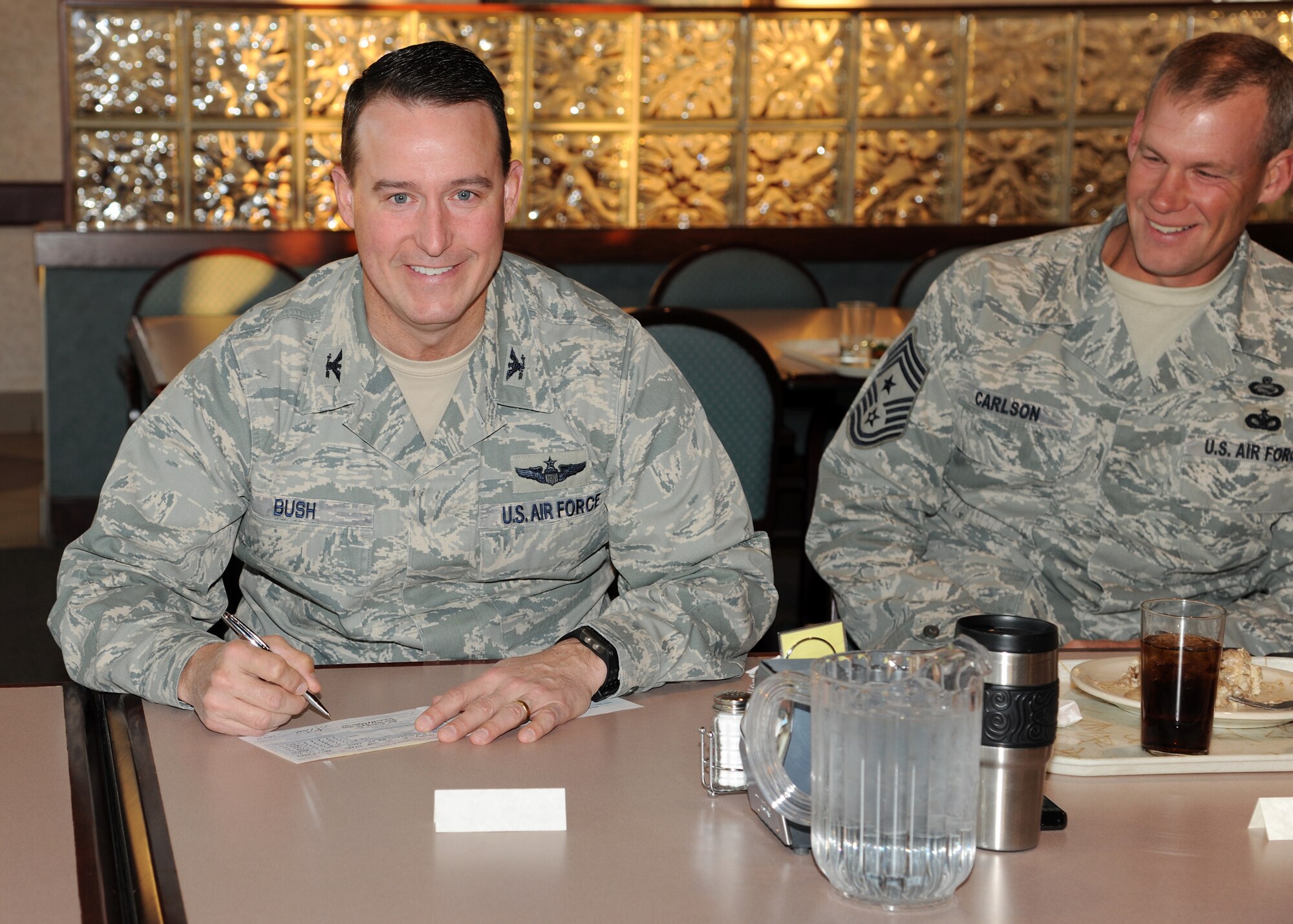 Col. Tim Bush, 319th Air Base Wing commander, fills out a donation card for the Combined Federal Campaign on Nov. 8 at Grand Forks Air Force Base, N.D. Last year the campaign raised nearly $241,000 and allowed donors to choose from more than 3,000 charities.  This year's goal for Grand Forks AFB is $50,000.(U.S. Air Force Photo by Airman 1st Class Ashley N. Taylor)
