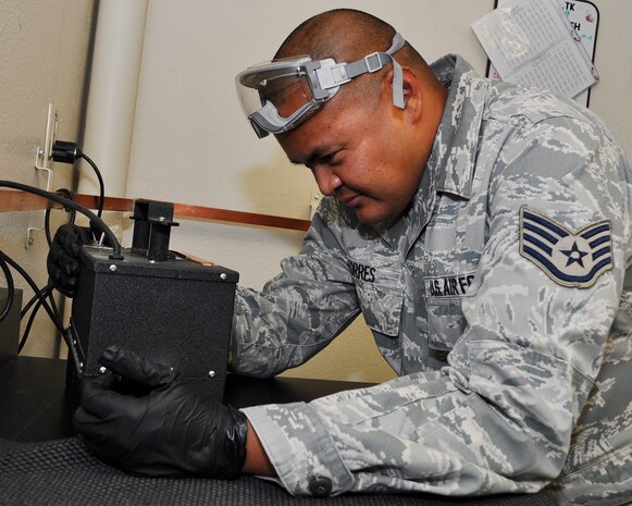 U.S. Air Force Staff Sgt. Dale Torres, 9th Logistics Readiness Squadron fuels technician, uses a Free Water Detector at the Beale Air Force Base, Calif., Fuels Lab, Nov. 8, 2011. The machine uses an ultra violet light to show traces of water in fuel.  This allows Torres to determine the amount of water present in fuel and ensure it is mixed properly.  (U.S. Air Force photo by Staff Sgt. Jonathan Fowler)
