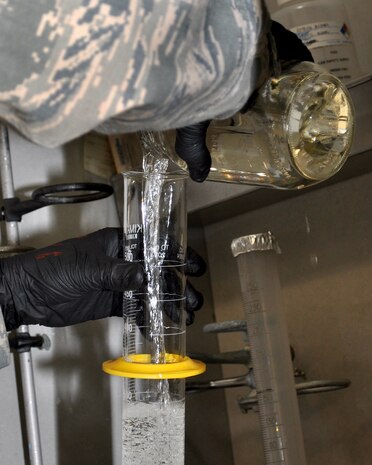 U.S. Air Force Staff Sgt. James Green, 9th Logistics Readiness Squadron fuels technician, pours fuel into a beaker at the Beale Air Force Base, Calif., Fuels Lab, Nov. 8, 2011. Green is testing the fuel's density to ensure that it meets the American Petroleum Institute's standards.  (U.S. Air Force photo by Staff Sgt. Jonathan Fowler)