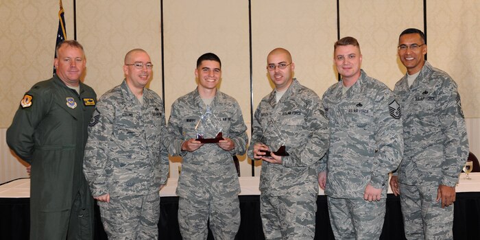Col. Erik Hansen (left) and Chief Master Sgt. Terrence Greene, along with Master Sgt. Brian Collins and Master Sgt. Mark O'Brien, present Airman 1st Class Jason Whipps and Senior Airman Nathaniel Diefenbach the Diamond Sharp award during a ceremony at the Charleston Club Nov. 8. Diamond Sharp awardees are Airmen chosen by their first sergeants for their excellent performance. Hansen is the 437th Airlift Wing commander, Greene is the 437th AW command chief, Collins and O'Brien are 437th Aircraft Maintenance Squadron assistant first sergeants and Whipps and Diefenbach are assigned to the 437th AMXS. Not pictured are Senior Airmen Sylvan Tortice, 437th Aerial Port Squadron and Airman 1st Cass Zachary Buzzard,14th Airlift Squadron, 437th AW. (U.S. Air Force photo/Airman 1st Class Ashlee Galloway)