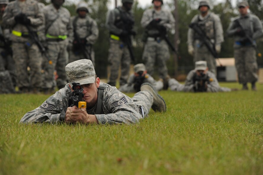 U.S. Air Force Staff Sgt. Brandon Sawyer, 23rd Civil Engineer Squadron explosive ordnance disposal apprentice, lies in prone position as he demonstrates firing techniques at Moody Air Force Base, Ga., Nov. 4, 2011. Sawyer was a part of a team that taught and demonstrated various combat tactics during Prime Base Engineer Emergency Forces training. (U.S. Air Force photo by Airman 1st Class Paul Francis/Released)

