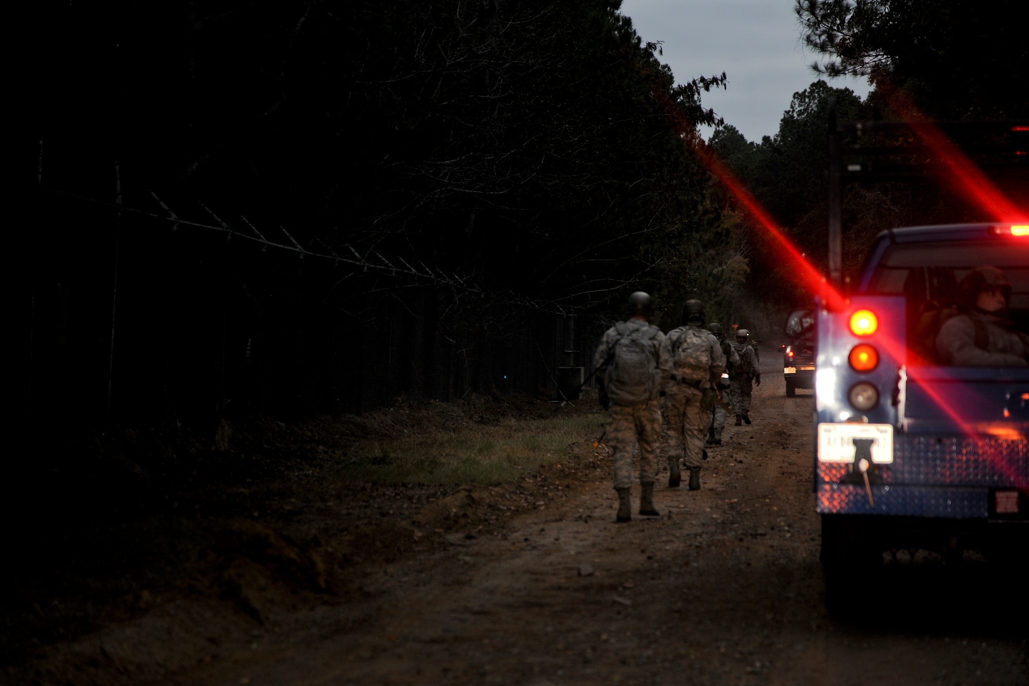 Members of the 23rd Civil Engineer Squadron march down a dirt road in column formation at Moody Air Force Base, Ga., Nov. 4, 2011. The squad also practiced tactical movements such as ducking and concealment to simulate a real world experience. (U.S. Air Force photo by Airman 1st Class Paul Francis/Released)
