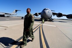 Staff Sgt. Kevin Sumlin walks to the 437th Aerial Port Squadron Passenger Terminal after performing a  pre-flight inspection on  a C-17 Globemaster III before a mission at Joint Base Charleston - Air Base Nov. 2. The Flying Crew Chiefs Office is a special duty assignment designed to provide a flying mission with a single-person maintenance package. Sumlin is a Flying Crew Chief with the 437th Aircraft Maintenance Squadron.  (U.S. Air Force photo/ Staff Sgt. Nicole Mickle)    