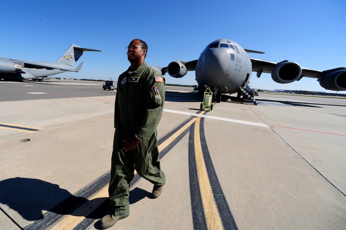 Staff Sgt. Kevin Sumlin walks to the 437th Aerial Port Squadron Passenger Terminal after performing a  pre-flight inspection on  a C-17 Globemaster III before a mission at Joint Base Charleston - Air Base Nov. 2. The Flying Crew Chiefs Office is a special duty assignment designed to provide a flying mission with a single-person maintenance package. Sumlin is a Flying Crew Chief with the 437th Aircraft Maintenance Squadron.  (U.S. Air Force photo/ Staff Sgt. Nicole Mickle)    
