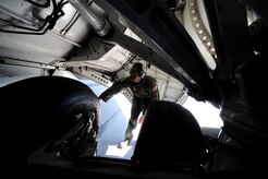 Staff Sgt. Kevin Sumlin performs a pre-flight inspection on the rear tires of  a C-17 Globemaster III before a mission at Joint Base Charleston - Air Base Nov. 2  Flying Crew Chiefs are trained in many specialized aircraft maintenance skills and provide universal support as the lone maintainer to fix most aircraft issues that may occur during a flying mission.  (U.S. Air Force photo/ Staff Sgt. Nicole Mickle)  