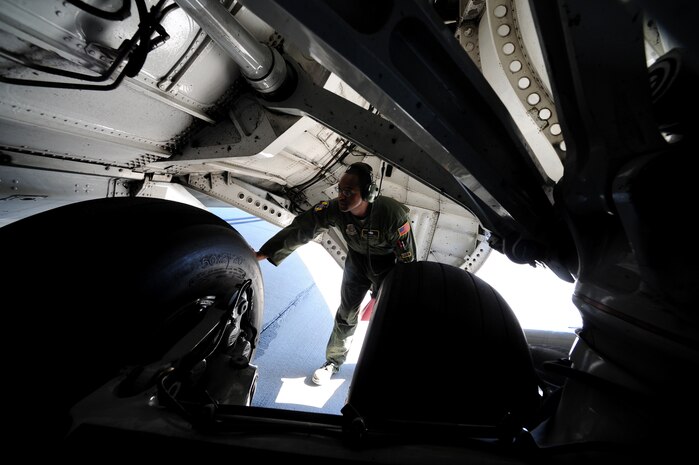 Staff Sgt. Kevin Sumlin performs a pre-flight inspection on the rear tires of  a C-17 Globemaster III before a mission at Joint Base Charleston - Air Base Nov. 2  Flying Crew Chiefs are trained in many specialized aircraft maintenance skills and provide universal support as the lone maintainer to fix most aircraft issues that may occur during a flying mission.  (U.S. Air Force photo/ Staff Sgt. Nicole Mickle)  