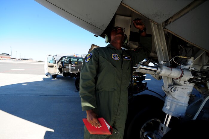 Staff Sgt. Kevin Sumlin performs a pre-flight inspection on the landing gear of  a C-17 Globemaster III before a mission at Joint Base Charleston - Air Base Nov. 2.  Flying Crew Chiefs are trained in many specialized aircraft maintenance skills and provide universal support as the lone maintainer to fix most aircraft issues that may occur during a flying mission. Sumlin is a Flying Crew Chief with the 437th Aircraft Maintenance Squadron.  (U.S. Air Force photo/ Staff Sgt. Nicole Mickle)  