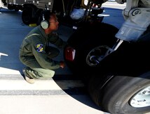Staff Sgt. Kevin Sumlin performs a pre-flight inspection on the front tires of  a C-17 Globemaster III before a mission at Joint Base Charleston - Air Base Nov. 2.  The Flying Crew Chiefs Office is a special duty assignment designed to provide a flying mission with a single-person maintenance package. Sumlin is a Flying Crew Chief with the 437th Aircraft Maintenance Squadron.  (U.S. Air Force photo/ Staff Sgt. Nicole Mickle) 