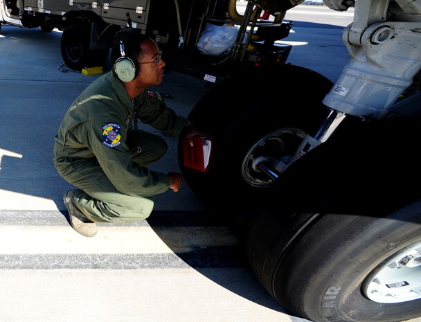 Staff Sgt. Kevin Sumlin performs a pre-flight inspection on the front tires of  a C-17 Globemaster III before a mission at Joint Base Charleston - Air Base Nov. 2.  The Flying Crew Chiefs Office is a special duty assignment designed to provide a flying mission with a single-person maintenance package. Sumlin is a Flying Crew Chief with the 437th Aircraft Maintenance Squadron.  (U.S. Air Force photo/ Staff Sgt. Nicole Mickle) 